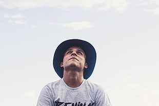 man wearing blue hat looking at the sky photo