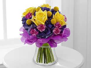 yellow,pink,and purple flowers in vase