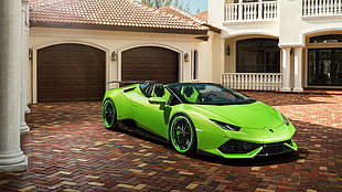 green Lamborghini sports car outside garage