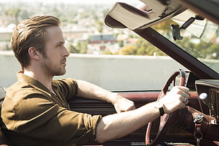photography of man wearing brown dress shirt driving on car HD wallpaper