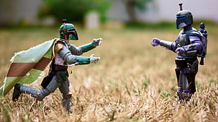 two green and gray Star Wars Clonetrooper action figures on beige grass