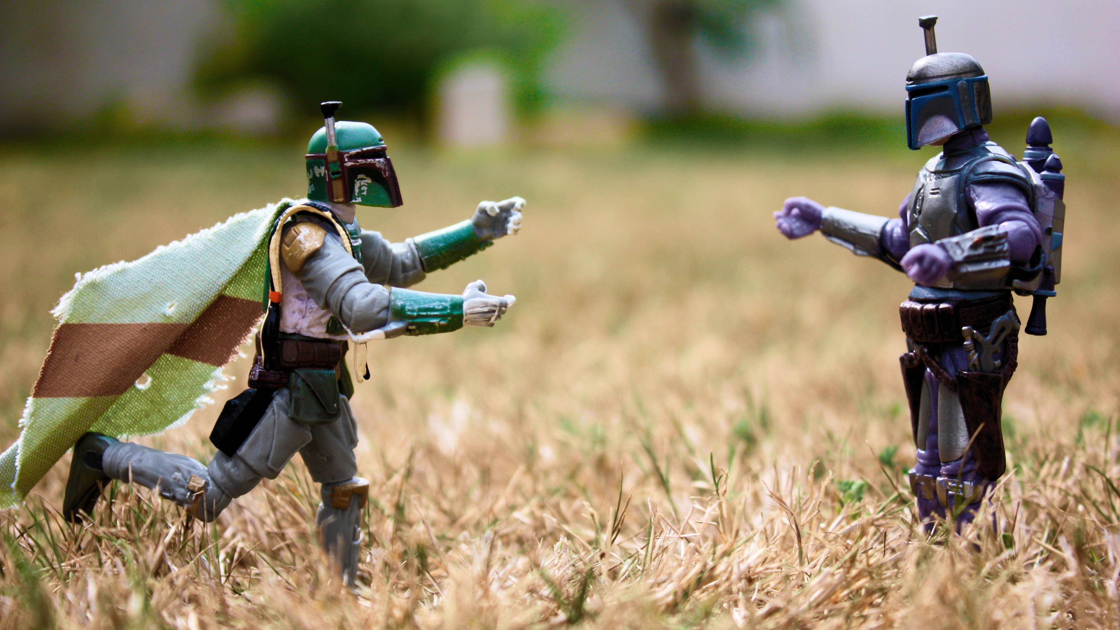two green and gray Star Wars Clonetrooper action figures on beige grass