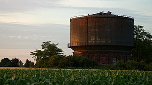 silo in green grass field during daytime