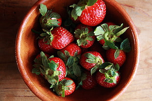 red Strawberries in brown ceramic bowl