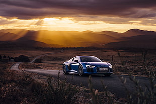 photo of blue car on road at golden hour