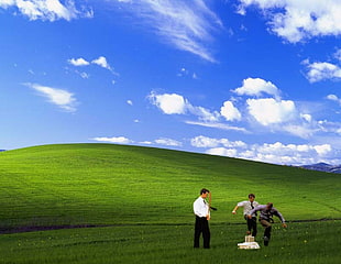 three person in middle on grass field wallpaper, clouds