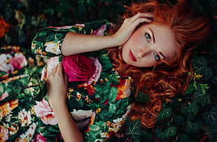 woman wearing green floral dress lying on grass