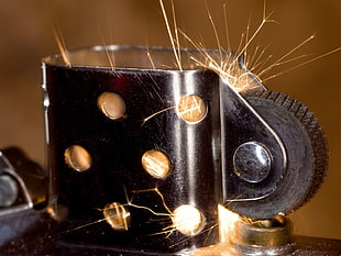 closeup photography of lighter with flint creating sparks