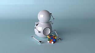 human figure playing rubrics cube on white surface