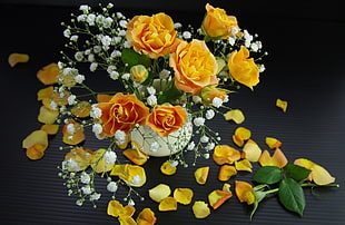 yellow Roses and baby's breath flowers in white vase