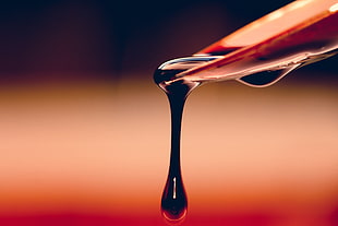 close-up photo of black liquid drips from spoon HD wallpaper