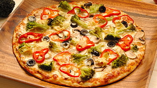 Pizza on brown wooden tray