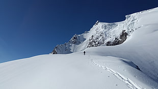 person walking on a mountain covered with snow