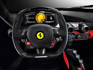 closeup photo of black Ferrari multifunction steering wheel