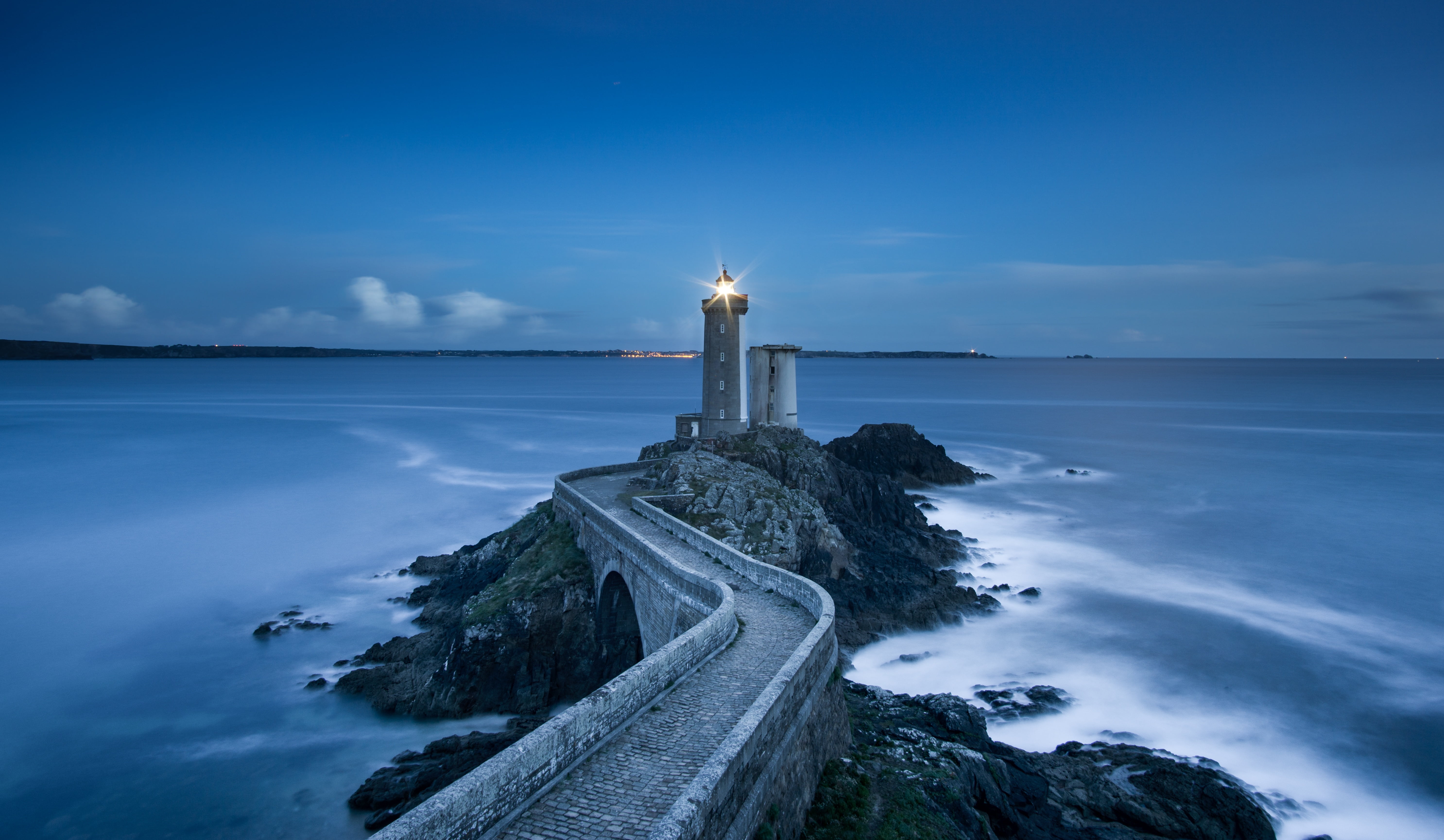 lighthouse on island under blue sky