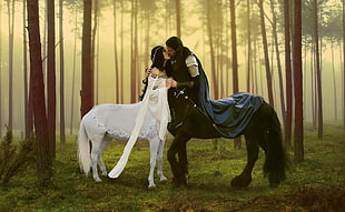 man and woman centaur kissing in the middle of the forest during daytime