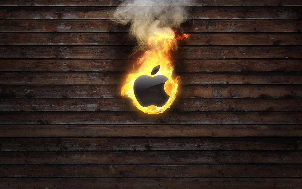 burning Apple logo on brown wooden panel HD wallpaper