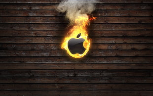 burning Apple logo on brown wooden panel HD wallpaper