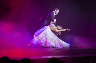 man and woman dancing on stage photo