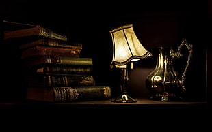pile of books and beige table lamp, lamp, books, table, lights