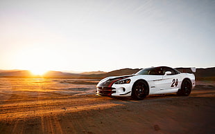 white and red coupe under golden hour