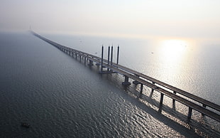 top view of gray bridge over the sea HD wallpaper
