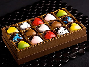 closeup photo of heart-shaped chocolates with cage