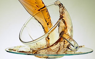 broken glass pouring brown liquid
