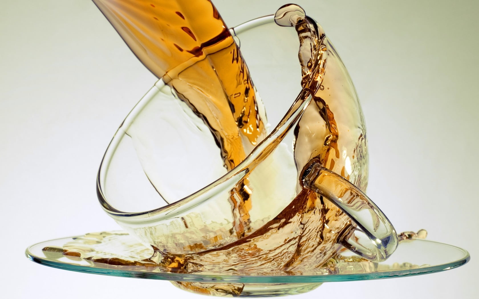 broken glass pouring brown liquid