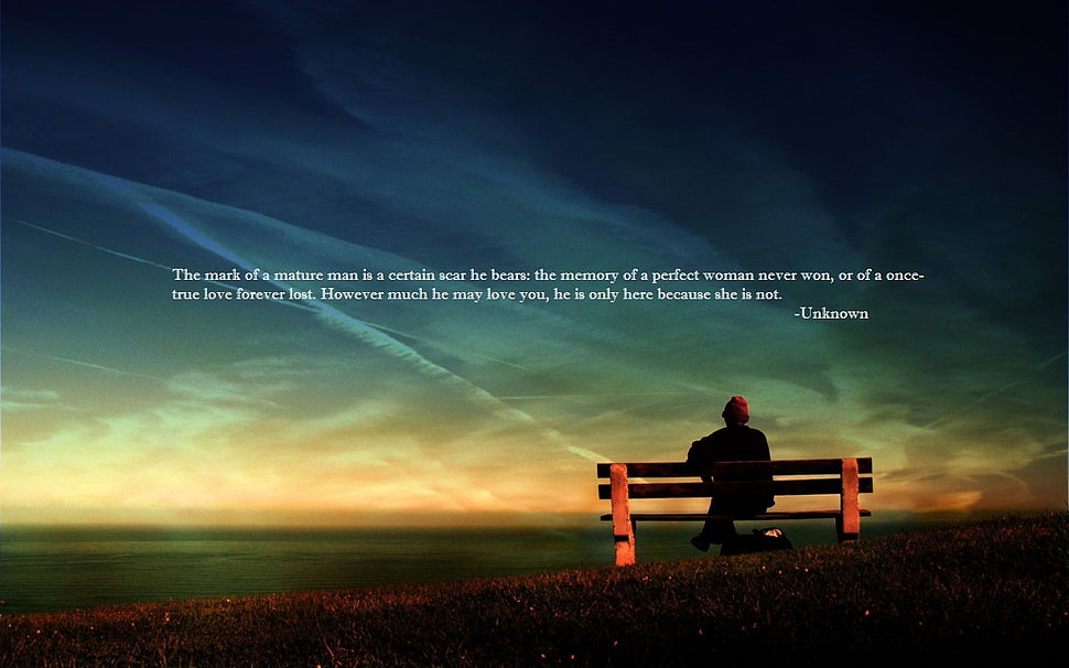 man sitting on brown bench under blue sky with text overlay HD wallpaper