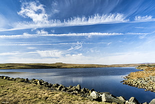 calm body of water beside rock with stratus clouds, selset reservoir