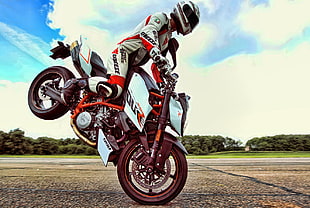 motorcycle racer doing motorcycle stunt HD wallpaper