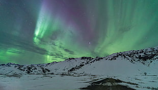 snow covered mountain under green sky during nighttime, iceland