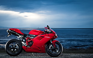 red sports bike by the sea