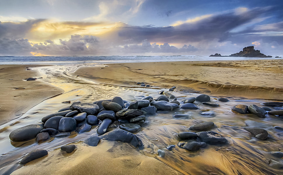 running  stream passing through gray stones HD wallpaper
