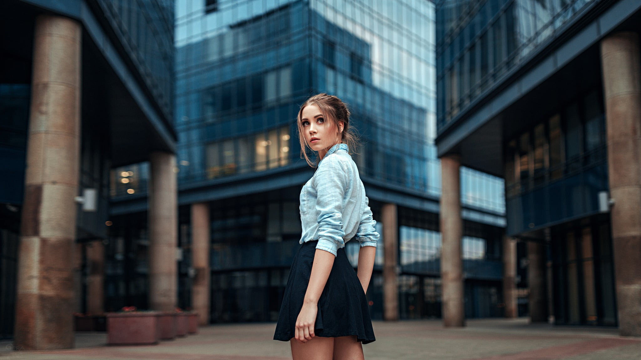 woman wearing blue dress shirt and black mini skirt