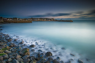 landscape photography of gray rocks in front of body of water, st ives