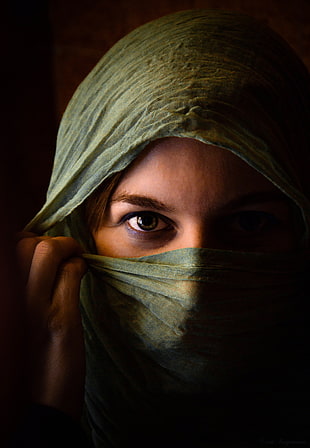 woman cover face with green scarf