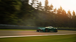 green sports coupe concept crossing road during golden hour