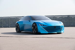 blue Peugeot concept car on gray road