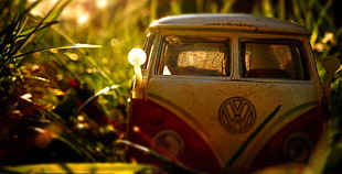 white and red Volkswagen van diecast on grass