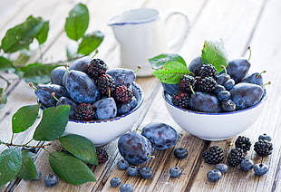 blackberries on white ceramic bowls
