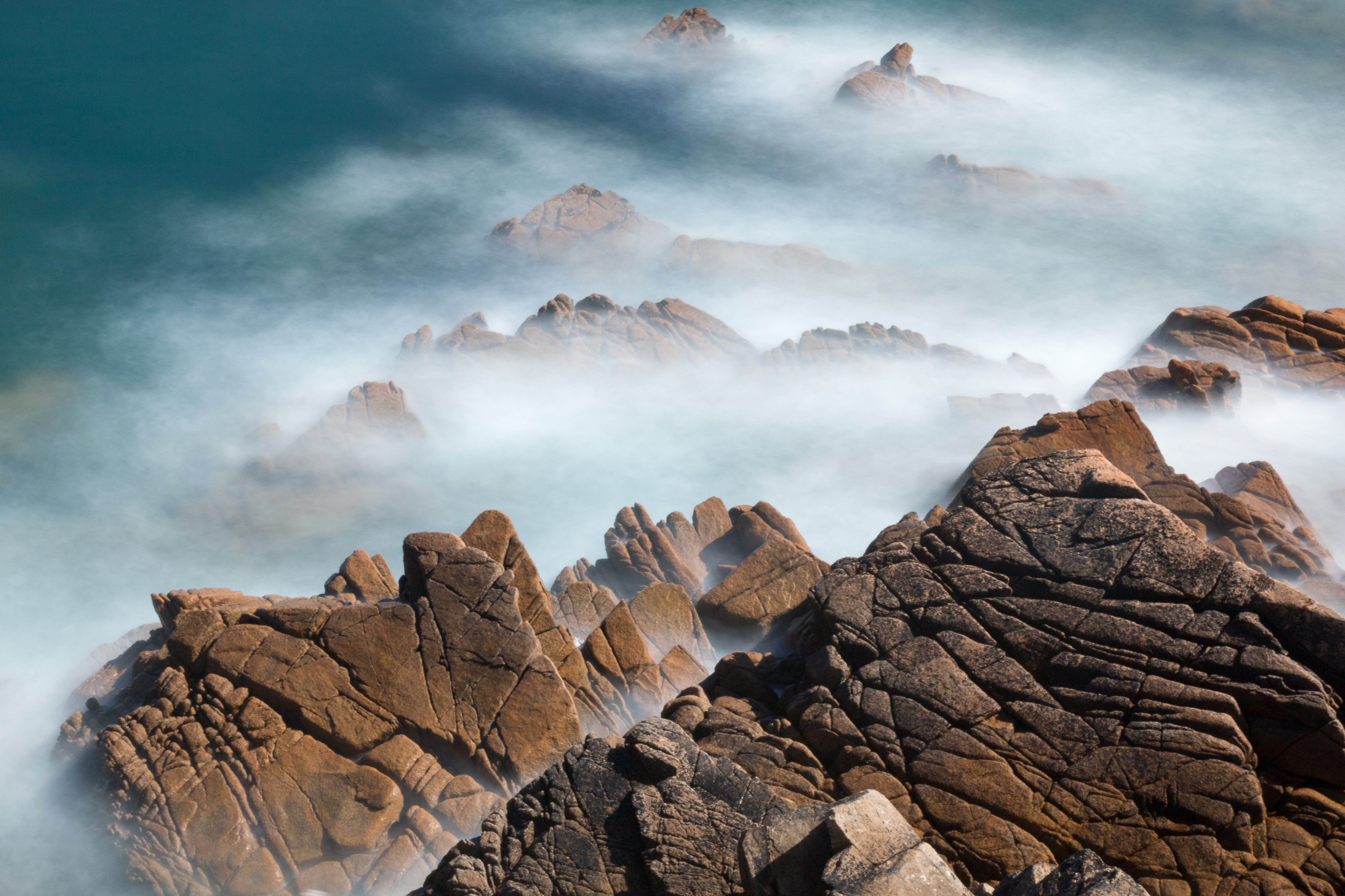 brown mountains with fog during day time photo