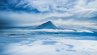 snow covered mountain under white cloudy sky