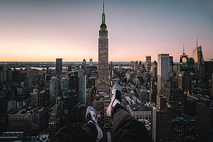 black pants and white Nike low-top sneakers, cityscape, rooftopping