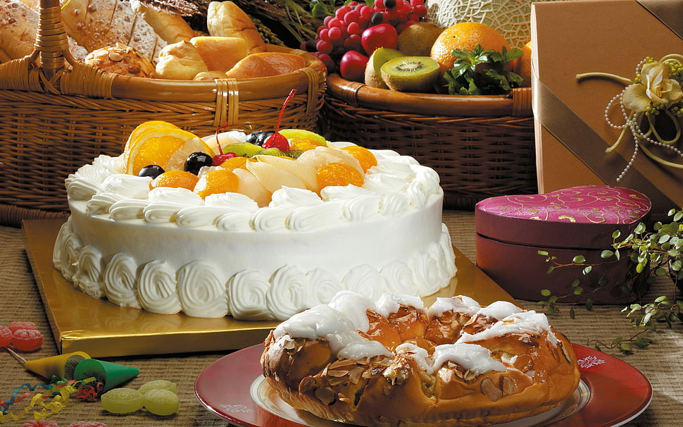 fruit-topped white cake on beige platform HD wallpaper