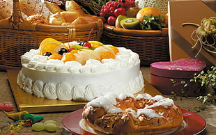 fruit-topped white cake on beige platform