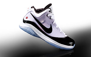 unpaired black and white Nike mid top sneakers
