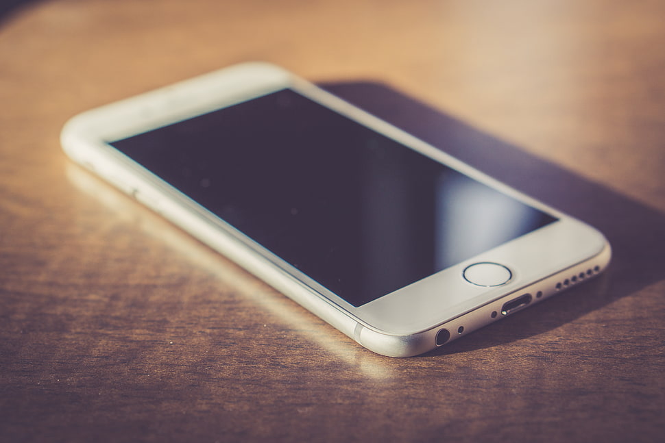 silver iPhone 6 on brown wooden surface HD wallpaper