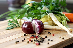 sliced onion with radish, cabbage, and pepper on chopping board